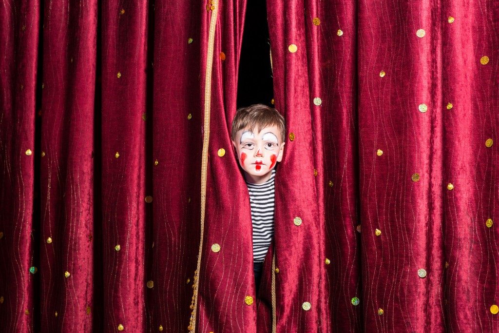 little boy behind the curtain