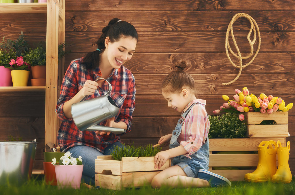 A child gardening with her mother