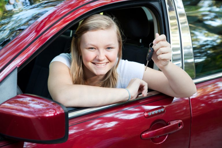happy teen girl with drivers license